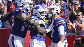 Buffalo Bills wide receiver Stefon Diggs, center, celebrates his touchdown with offensive tackle Spencer Brown, left, and quarterback Josh Allen, right, during the first half an NFL football game against the Miami Dolphins, Sunday, Oct. 1, 2023, in Orchard Park, N.Y. (AP Photo/Jeffrey T. Barnes)