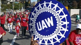 United Auto Workers members walk in the Labor Day parade in Detroit, Sept. 2, 2019. The tentative contract agreement between General Motors and the United Auto Workers union appears to be headed for defeat. The union hasn’t posted final vote totals yet, but workers at five large factories who finished voting in the past few days have turned down the four year and eight month deal by fairly large margins.