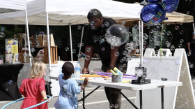 Children play with bubbles at Community Spring's block party.
