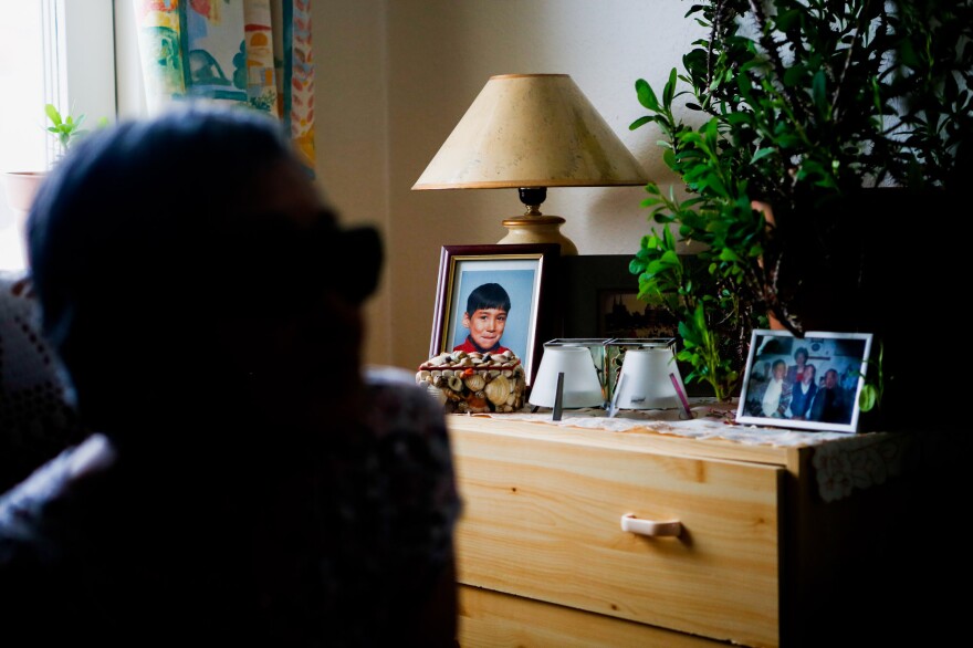 A portrait of one of Atsa Schmidt's grandsons sits on a dresser in her Nuuk living room.