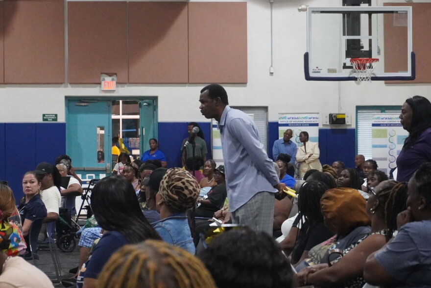 An attendee takes the microphone to voice his concerns as county officials field questions during the Oct. 8 meeting at the NFL YET Center.