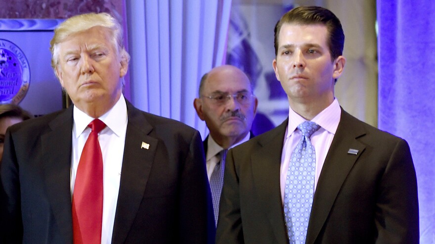 Trump Organization Chief Financial Officer Allen Weisselberg (center) stands behind then-President-elect Donald Trump and his son Don Jr. on Jan. 11, 2017, at Trump Tower in New York.