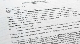 A court filing by lawyers for former President Donald Trump is photographed Monday, Aug. 22, 2022, as lawyers ask a federal judge to prevent the FBI from continuing to review documents recovered from his Florida estate until a neutral special master can be appointed. The attorneys asserted in a court filing, their first since the FBI search of Mar-a-Lago two weeks ago, that the sets of documents taken from the residence were "presumptively" covered by executive privilege. (AP Photo/Jon Elswick)