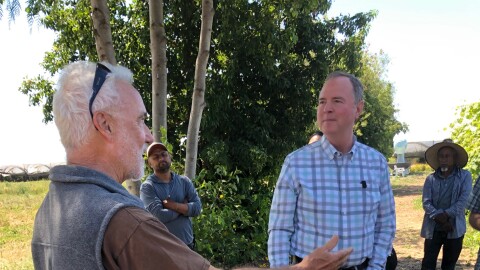 U.S. Senator Adam Schiff of California talks with farmer Phil McGrath during a visit to McGrath's Camarillo farm Thursday.