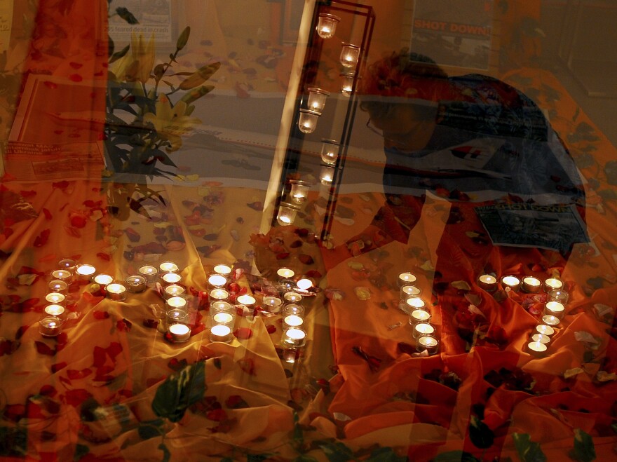 Candles commemorating the dead spell out MH17, the flight number of the plane that crashed Thursday, at a church in Kuala Lumpur on Friday.