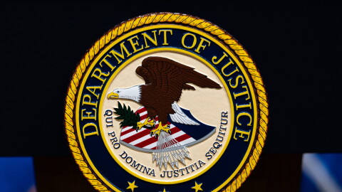 FILE - The U.S. Department of Justice logo is seen on a podium before a news conference, May 4, 2026, in Washington.