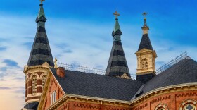 The exterior of Old St. Mary Catholic Church in Detroit in front of a blue sky.
