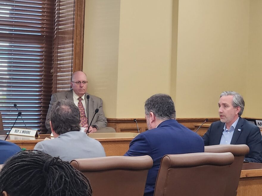 Aaron Jennen (right), a father of a transgender teenager from Fayetteville, speaks against Senate Bill 270 before the House Judiciary Committee on March 28, 2023. Sen. John Payton (R-Wilburn, left) is the bill’s sponsor.