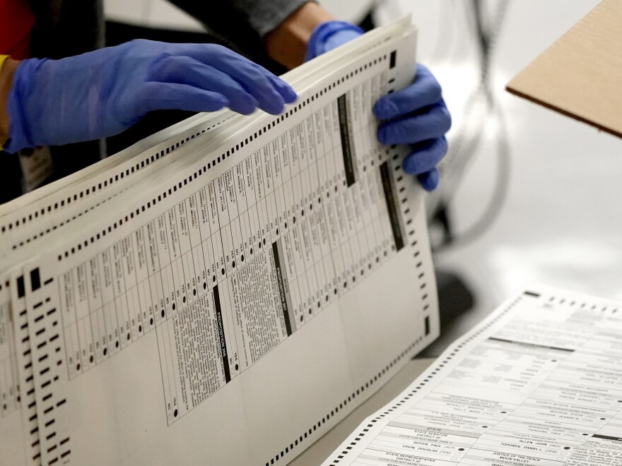 Maricopa County, Ariz., elections officials count ballots on Nov. 4, 2020, at the Maricopa County Recorder's Office in Phoenix. Eight years after carving the heart out of a landmark voting rights law, the Supreme Court put new limits on efforts to combat racial discrimination in voting.