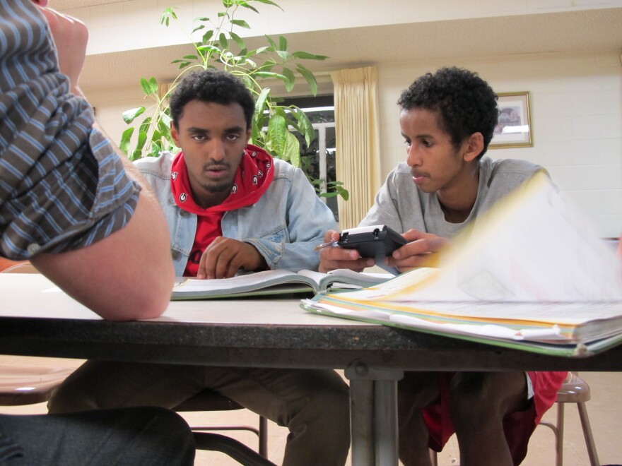 Micky Zegaye (left) works with a tutor at Fugee Academy in Clarkston, GA.