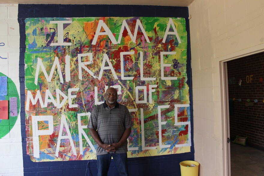 State Rep. Tommie Pierson, D-Bellefontaine Neighbors, stands in front of a mural at his church's school. Pierson is the senior pastor at Greater St. Mark Family Church, which played a big role during the unrest in and around Ferguson.