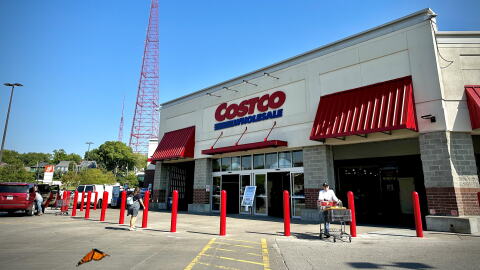 Entrance to the Costco store in Midtown Kansas City with a tall red broadcast tower and a butterfly