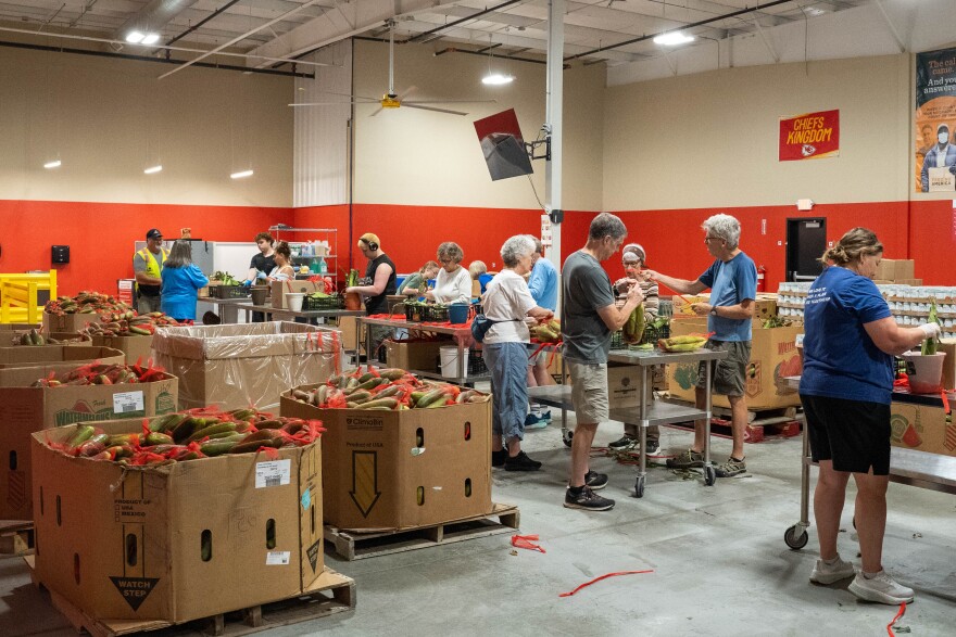 At the Harvesters food bank distribution center in Lawrence, Kansas, volunteers pack produce destined for a local food pantry.