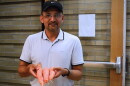 Resham Thapa, an associate research professional in the Center for Carbon Capture and Conversion at the University of Wyoming School of Energy Resources, holds up some of the carrots grown with coal char in the soil.