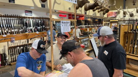 Matt Dusek, left, indoor range manager at Sprague's Sports in Yuma, helps weigh a dove as part of the annual "Big Breast" competition during dove hunting season.