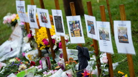 Rain soaked memorials for those who died sit along the roadside by Schemengees Bar & Grille, Monday, Oct. 30, 2023, in Lewiston, Maine.