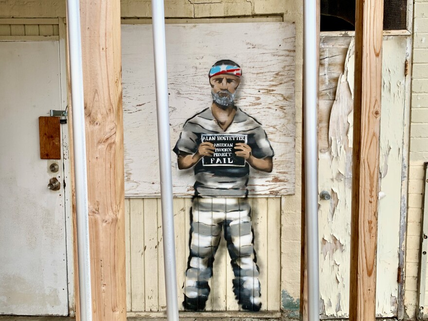 After Alan Hostetter was indicted, a graffiti artist known as "Bandit" painted this image of Hostetter in a prison jumpsuit on a street in San Clemente, Calif. The image was painted over within a week.