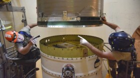 In this image provided by the U.S. Air Force, Airman 1st Class Jackson Ligon, left, and Senior Airman Jonathan Marinaccio, 341st Missile Maintenance Squadron technicians connect a reentry system to a spacer on an intercontinental ballistic missile during a Simulated Electronic Launch-Minuteman test Sept. 22, 2020, at a launch facility near Malmstrom Air Force Base in Great Falls, Mont. The Air Force has temporarily closed two nuclear launch facilities after finding unsafe levels of a likely carcinogen in air samples at a Montana missile base where a striking number of men and women who served have reported cancer diagnoses.