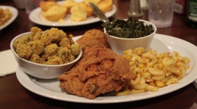 Image of a plate of soul food, including fried chicken, mac and cheese, collards, and fried okra.