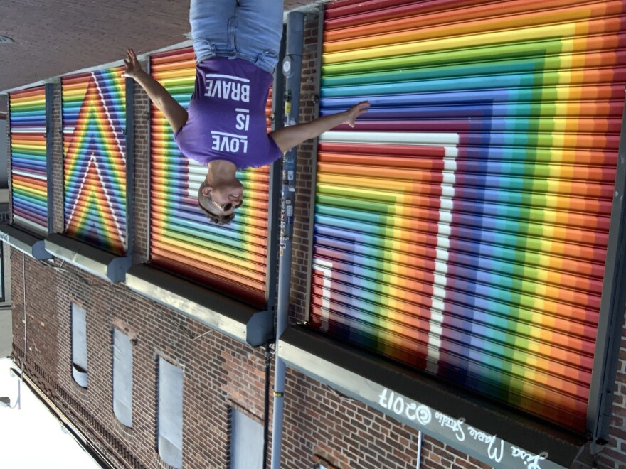 Lisa Marie Thalhammer poses last summer in front of her 2017 <em>LOVE</em> mural in D.C.'s Blagden Alley.