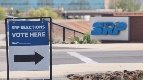 A sign directing voters sits outside the headquarters of Salt River Project on Monday, March 30, 2026, in Tempe, Ariz.