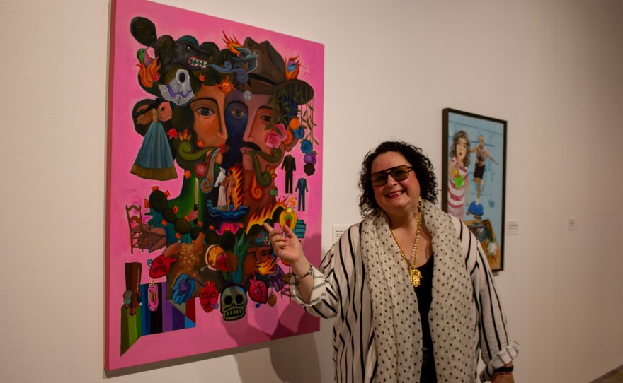 Alejandra ‘Mera Mera' Sanchez Alanís standing next to one of Hector Garza's artworks.