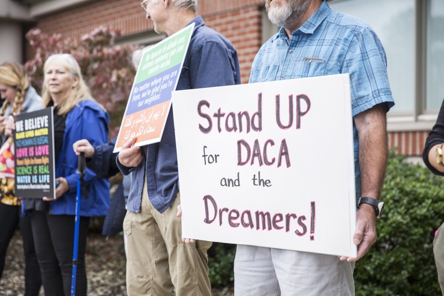 Protestors held signs that read "stand up for DACA"