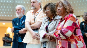 Freedom Riders and descendants, from left, Steve Thomas, Max Heller, Margaret Petway, and her sister, Kredelle Petway-Phillips, hold hands while singing at Xavier University of Louisiana in New Orleans, Wednesday, Oct. 28, 2026. (Christiana Botic/Verite News and Catchlight Local/Report for America via AP)