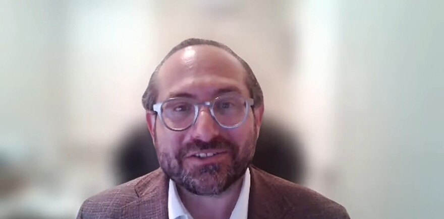 Man with beard and jacket and glasses 