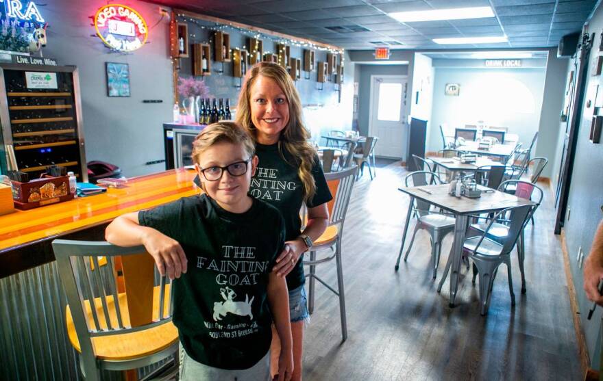 Ashley Driemeyer, co-owner of The Fainting Goat, and her son, Dalton, pose in the main bar and seating area of their Breese location. Driemeyer is frustrated with the state restrictions and like several restaurant and bar owners in the region, she is defying the orders and opening indoor areas to service.