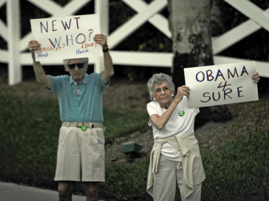 Two people protest Republican presidential hopeful Newt Gingrich outside a Republican Jewish Coalition rally Friday in Delray Beach, Fla.