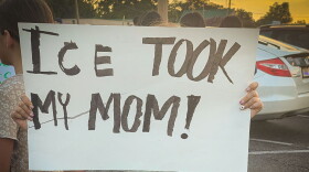A child protests the ICE arrest of 121 people from a restaurant in Memphis on Aug. 31.
