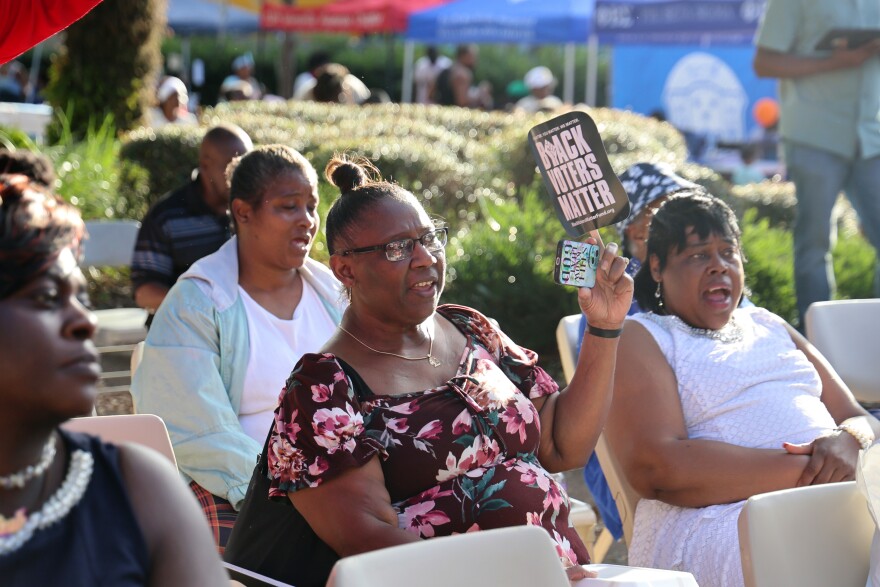 Spectators watch a music performance at a Souls to the Polls and Empowerment Sunday event in Gainesville, Fla., Sunday, Nov. 3, 2024. The event was held outside the Alachua County Supervisor of Elections office on the last day of early voting. (Diego Perdomo/Fresh Take Florida)