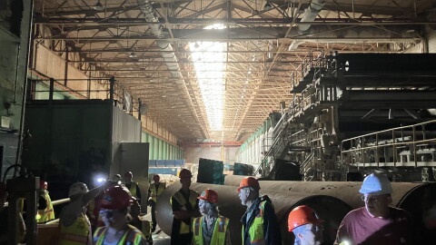 Participants in one of the first public tours of the former Pactiv Evergreen paper mill walk through the facility Thursday, Aug. 13, 2026.