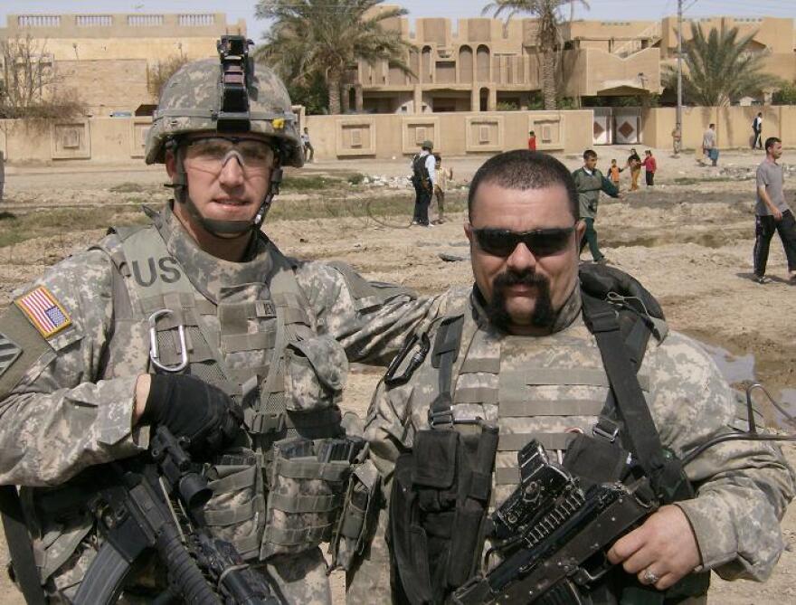 Brian Dennison (left) at a humanitarian aid drop in Rumadi, Iraq with a Kurdish interpreter. When he concluded his Army career, Dennison had achieved the rank of Captain.
