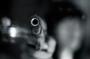 closeup of the barrel of a handgun with the background blurred