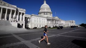 A person runs on the East Front of the U.S. Capitol, Friday, Oct. 17, 2025, in Washington.