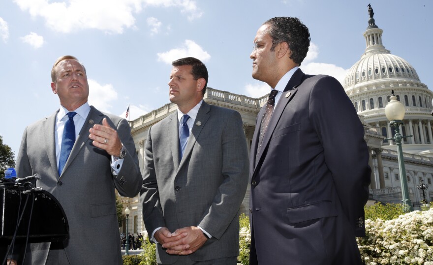 Rep. Jeff Denham, R-Calif., (left) speaks next to Rep. David Valadao, R-Calif., and Rep. Will Hurd, R-Texas, during a May 9 news conference on a discharge petition to force votes on immigration legislation.