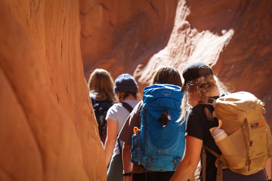 Visitors hike through Dry Fork Narrows in Utah’s Grand Staircase-Escalante National Monument, March 10, 2025.