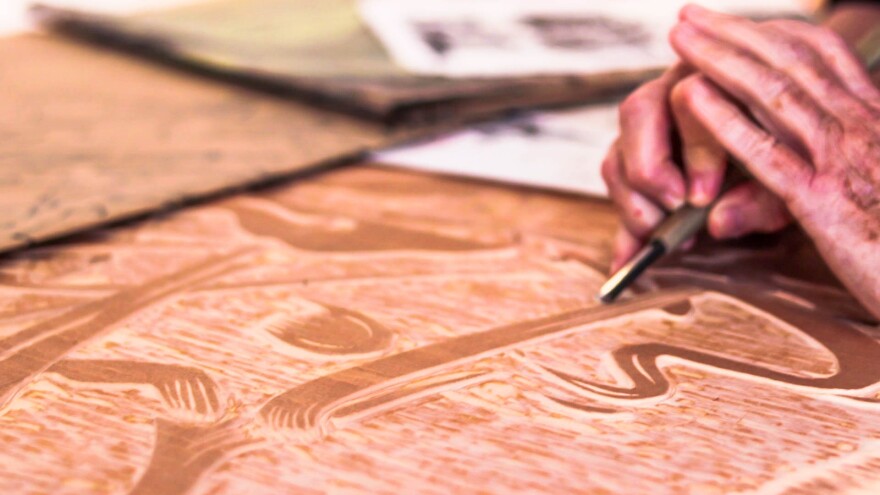 Polly Perkins, a St. Petersburg, FL based artist, demonstrates how to carve a woodblock using an ancient Japanese tool. Thomas Iacobucci/WUSF Public Media