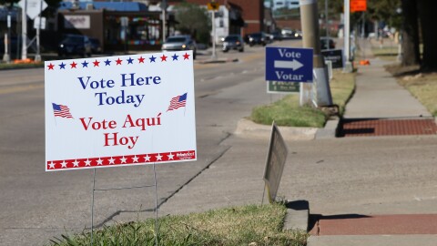 A sign with the message "Vote Here Today" is posted near the entrance to the Denton Civic Center parking lot.
