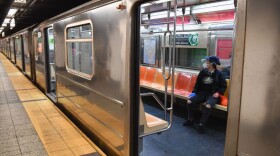 A commuter rides in a MTA subway car during morning rush hour on June 8, 2020, in New York City. (Angela Weiss/AFP/Getty Images)