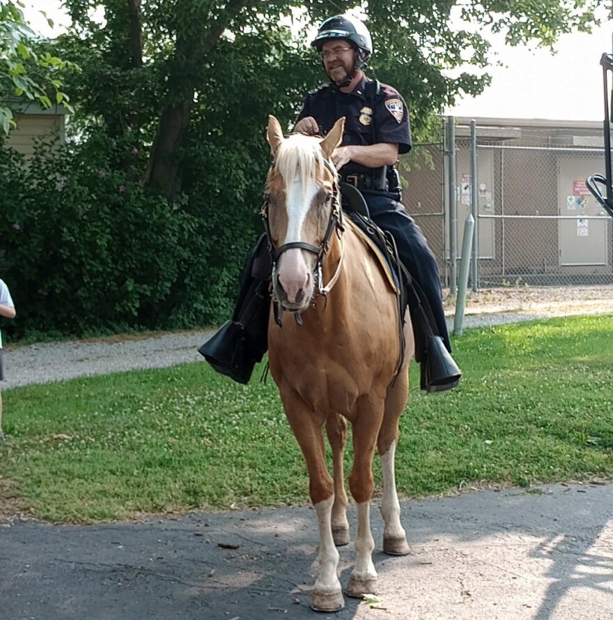 An Evansville Police officer rides Scotty in this file photo