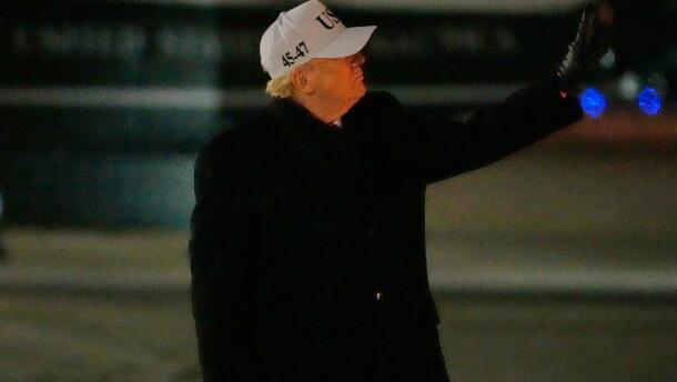 President Donald Trump gestures to a person walking down the stairs behind him as he arrives on Air Force One, Tuesday, Jan. 27, 2026, at Joint Base Andrews, Md., after returning from a trip to Iowa. (AP Photo/Mark Schiefelbein)