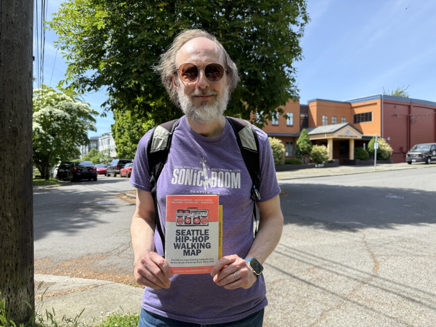 Gary Campbell holds a copy of Seattle Hip Hop Walking Map outside the Rotary Boys and Girls Club in Seattle's Central District. This is on stop on Campbell's tour of local hip-hop history.