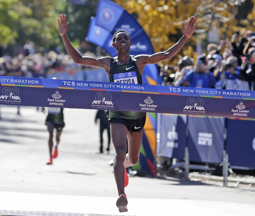 Lelisa Desisa, of Ethiopia, crosses the finish line first in the men's division of the NYC Marathon.