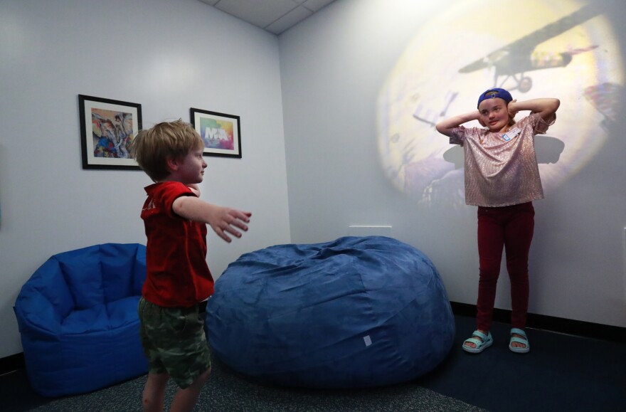 Lizzie Sando, right, 11, and her brother Teddy, 5, check out Miami International Airport's new Multi-Sensory Room, Friday, April 19, 2019, in Miami. The room will be a quiet area for young passengers with cognitive or developmental disabilities, providing a relaxing environment during their travels.
