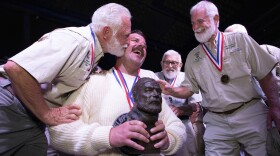 A kiss for the new Papa. Former Hemingway Look-Alike Contest winners welcome Chris Dutton, 39, of Tampa, Fla., into their ranks at Sloppy Joe’s Bar in Key West, Fla., Saturday, July 25, 2026, after he became the youngest winner in the contest’s 45-year history and the first “Young Hemingway” to claim the coveted title. Organizers registered 134 contestants across two preliminary rounds before Dutton defeated 23 other finalists to claim the title.