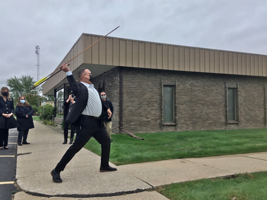Miguel Cardona, the U.S. secretary of education, throws a spear after a brief primer on technique at the Saginaw Chippewa Tribal College in Mount Pleasant on Thursday.