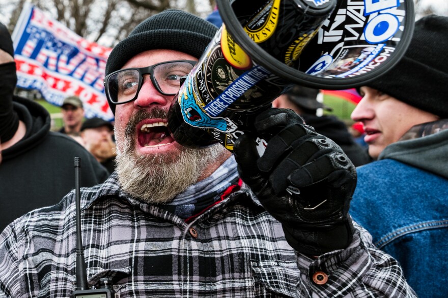Joseph Biggs, a Proud Boys leader, uses a megaphone during a march in front of the Capitol Building on January 6, 2021 in Washington, DC. A pro-Trump mob stormed the Capitol, breaking windows and clashing with police officers. Trump supporters gathered in the nation's capital today to protest the ratification of President-elect Joe Biden's Electoral College victory over President Trump in the 2020 election.
